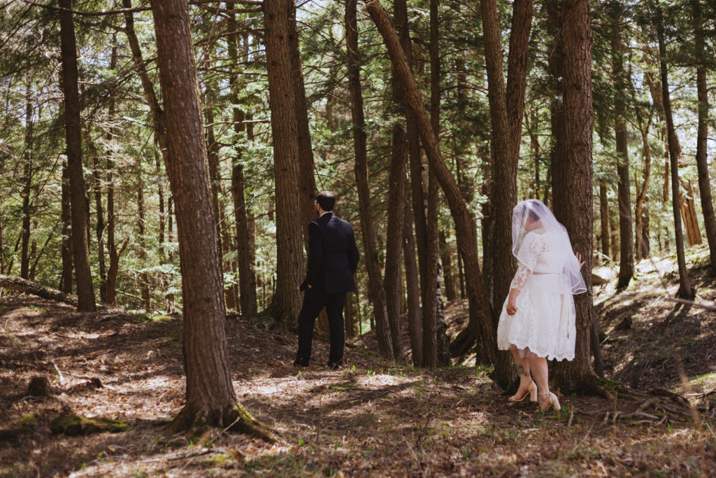 bride walking into the forest for first look