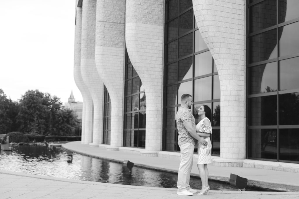 engaged couple standing outside the Canadian Museum of History in black and white