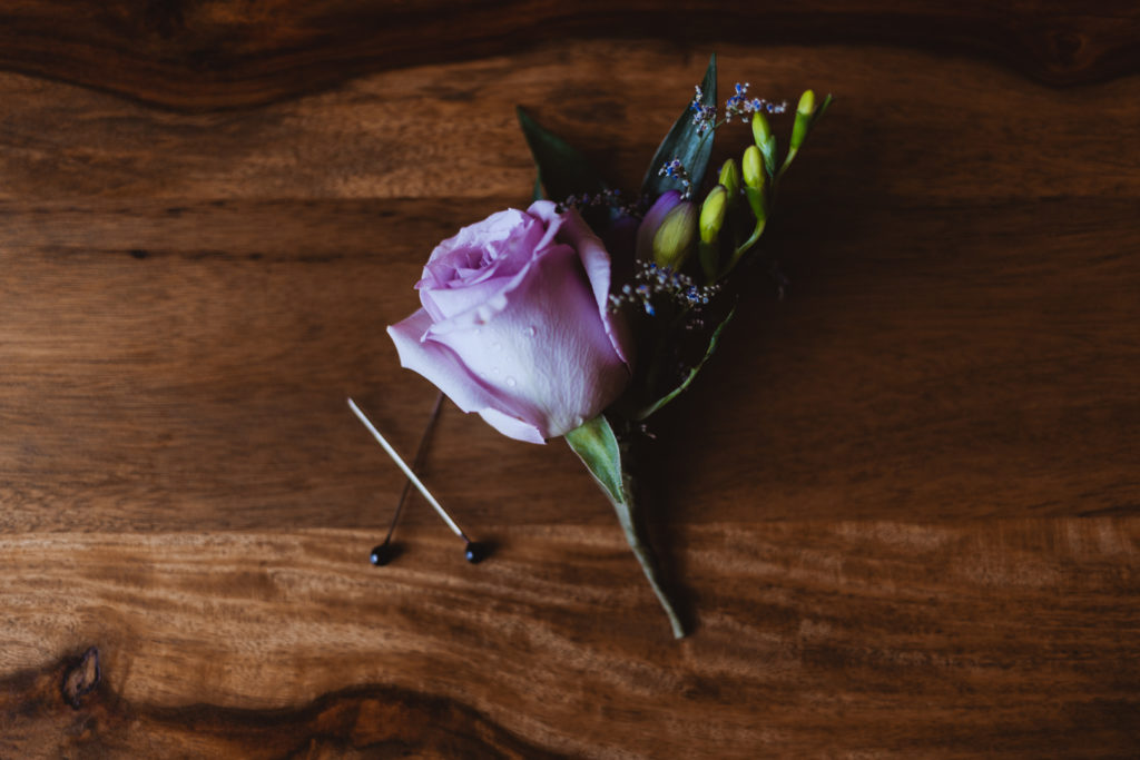 groom's purple and green boutonniere