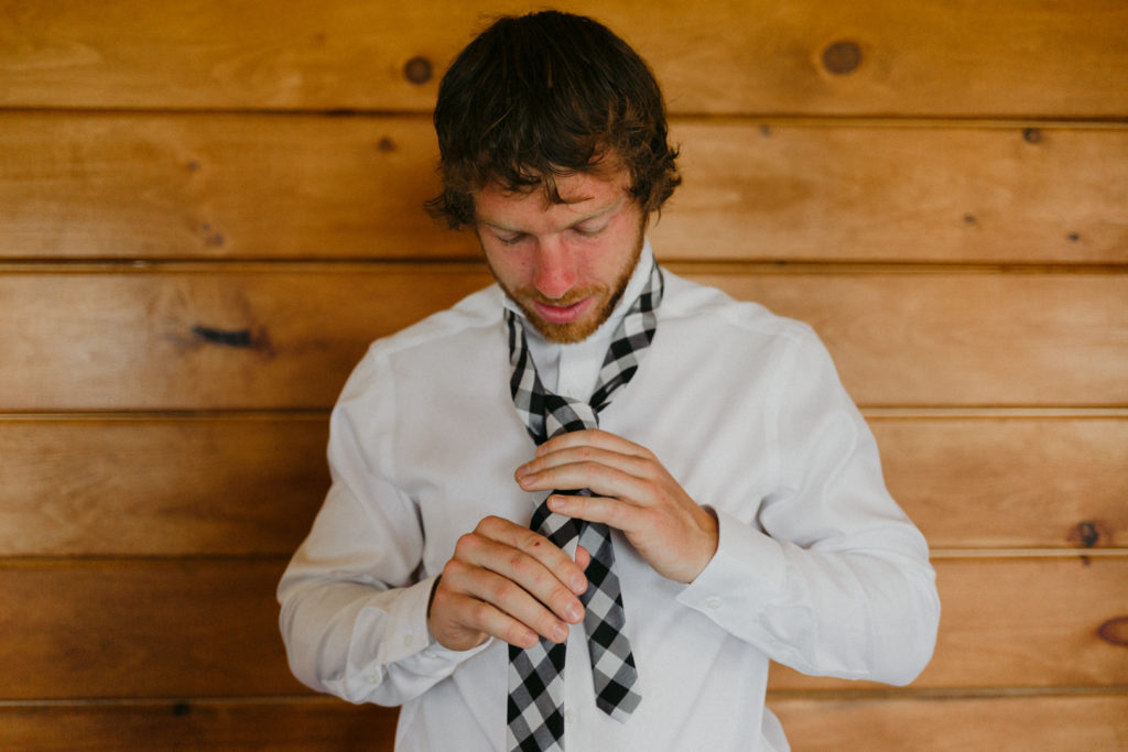 groom tying up his tie