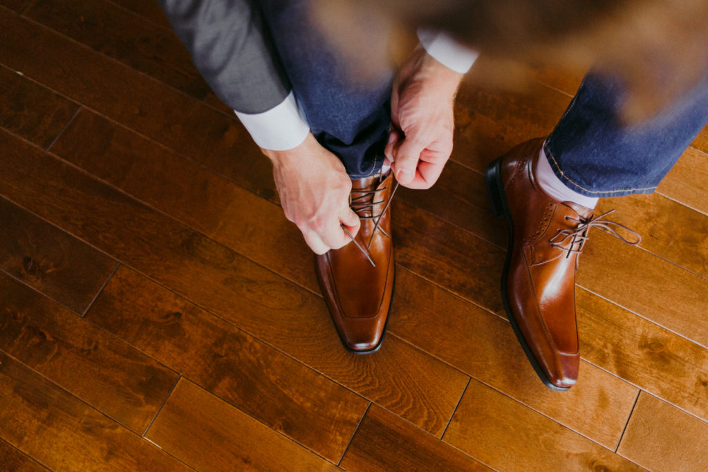 groom tying up his shoes