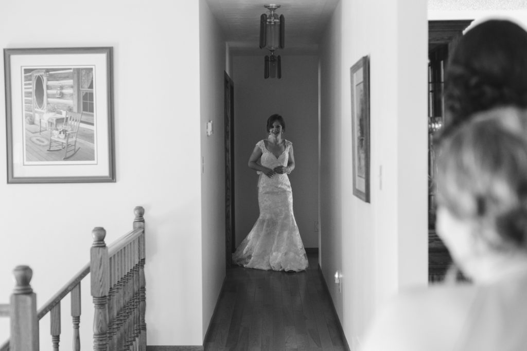 bride walking down the hallway wearing her wedding dress