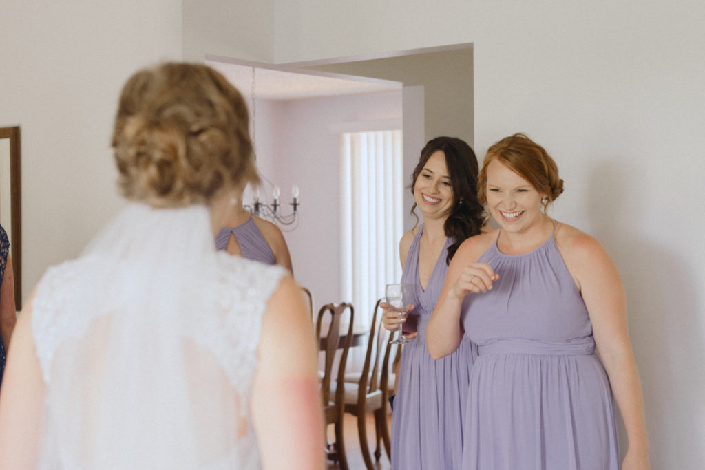 bridesmaids seeing the bride in her dress for the first time