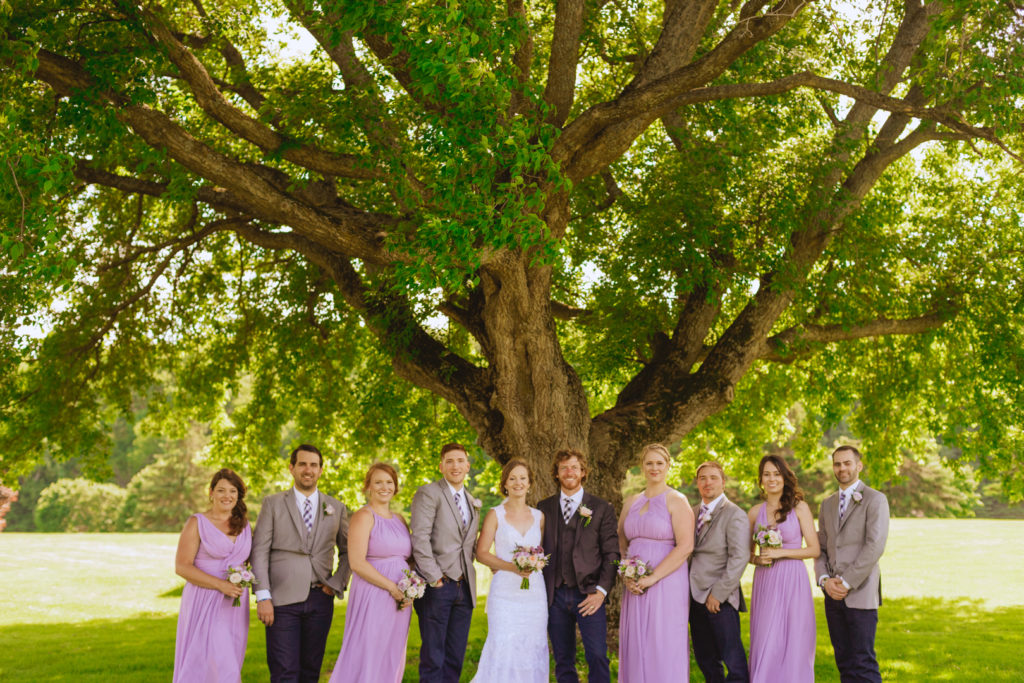 wedding party standing under a maple tree at the Oaks of Cobden golf club