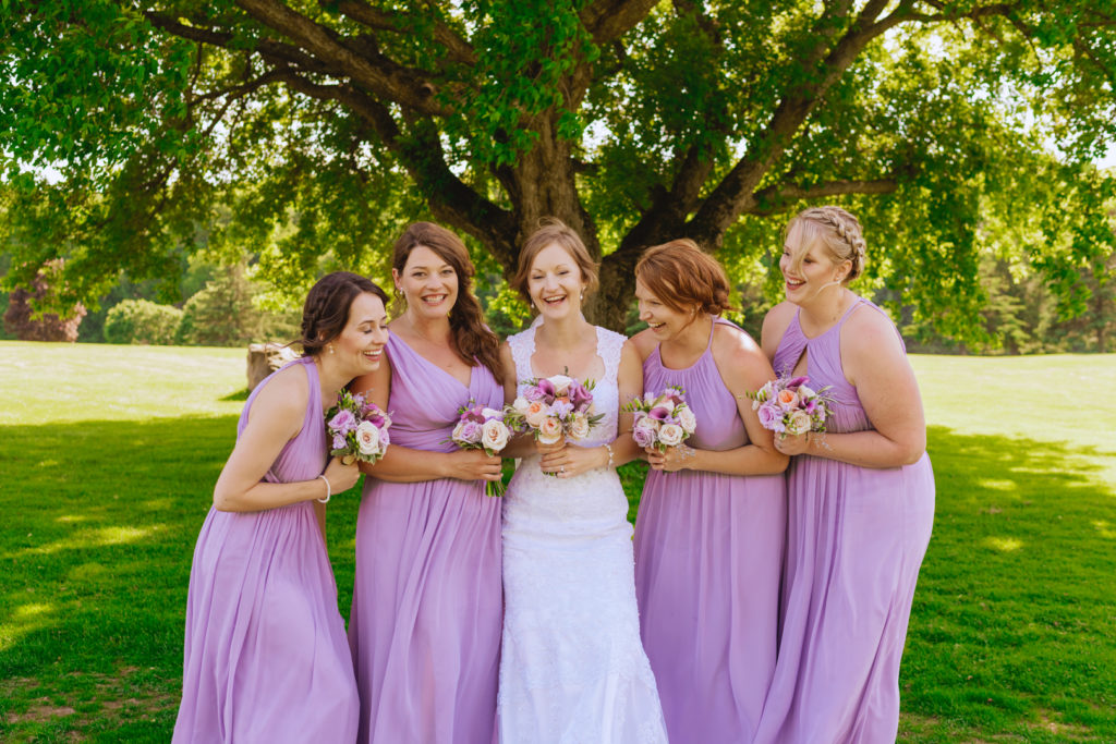 bridesmaids standing under a maple tree at the Oaks of Cobden golf club