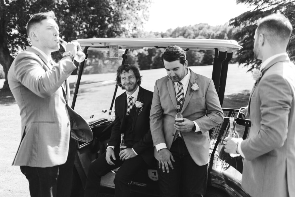 groom and groomsmen hanging out on golf carts at the Oaks of Cobden golf club