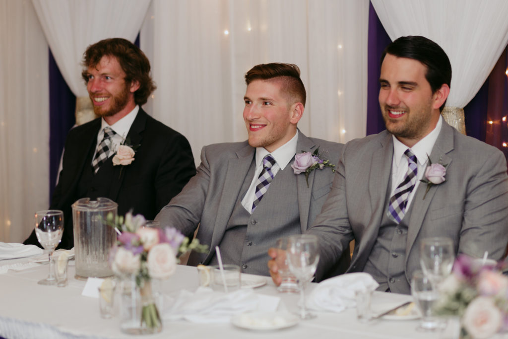 groom and groomsmen laughing at speeches