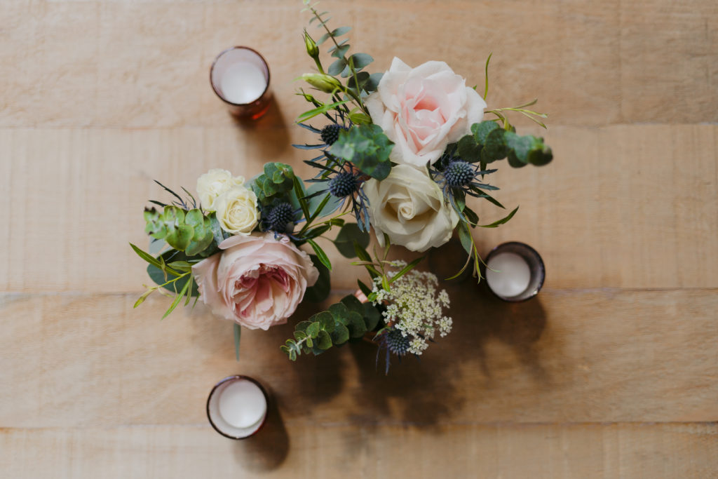 flowers and candles on wooden table