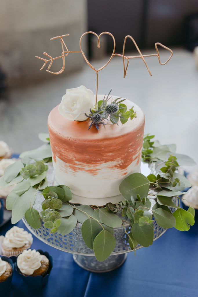 wedding cake with rose gold cake topper with initials