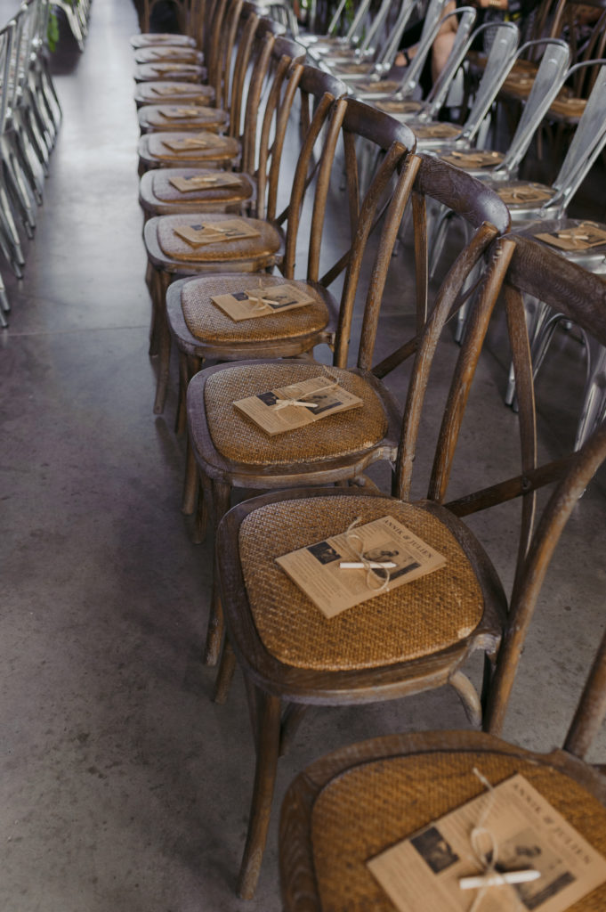 wedding ceremony programs on wooden wicker chairs