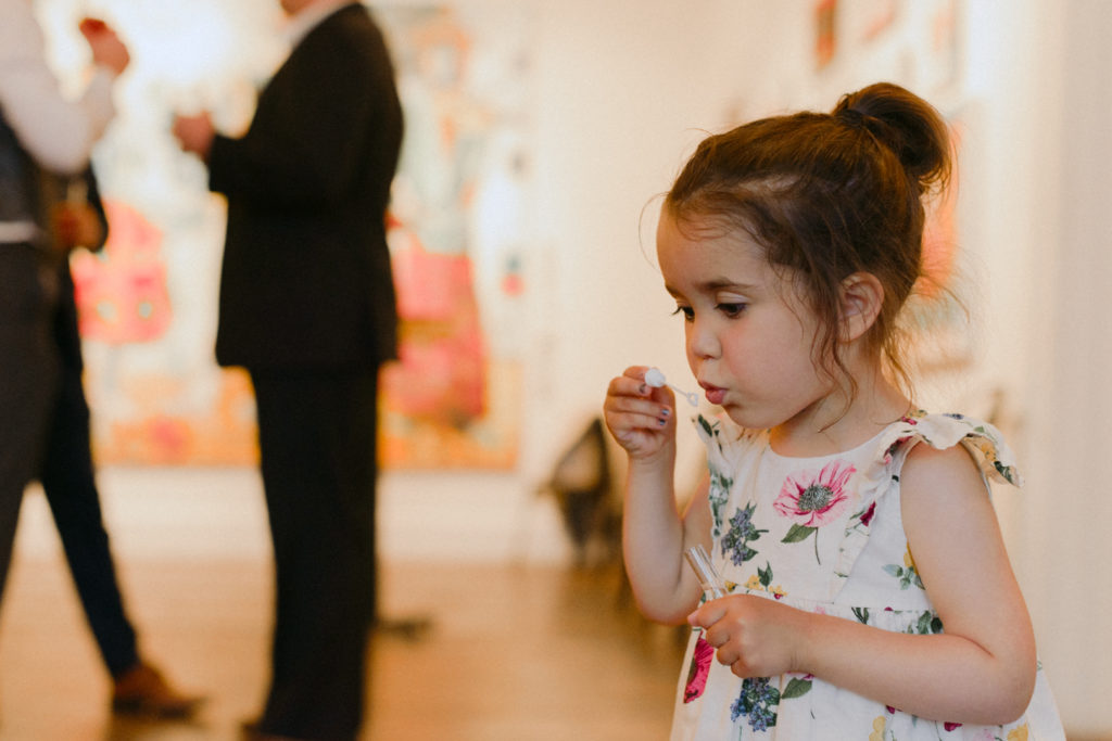 Little girl blowing bubbles at a wedding