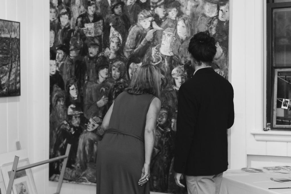 wedding guests looking at art