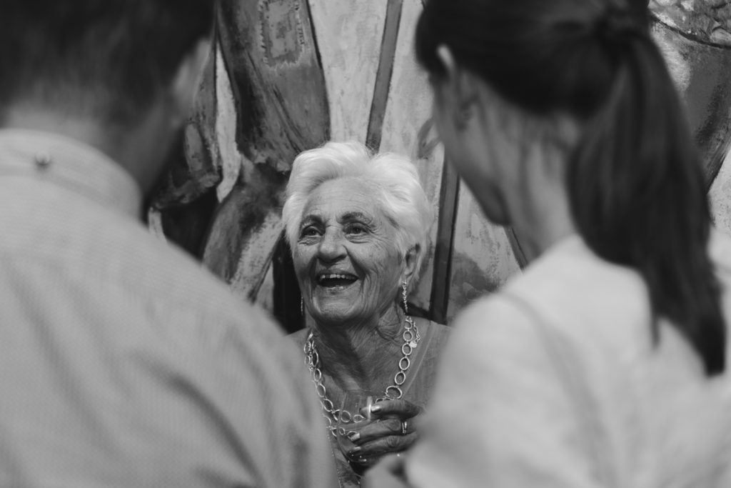 bride's grandmother laughing at wedding guests