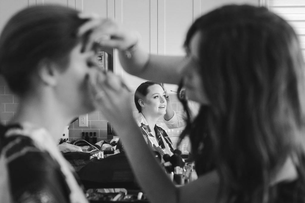 bride having her makeup done in the kitchen