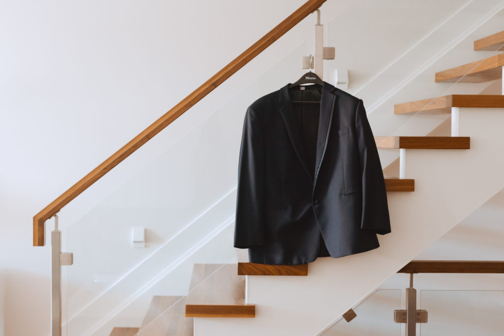 groom's suit jacket hanging from railing