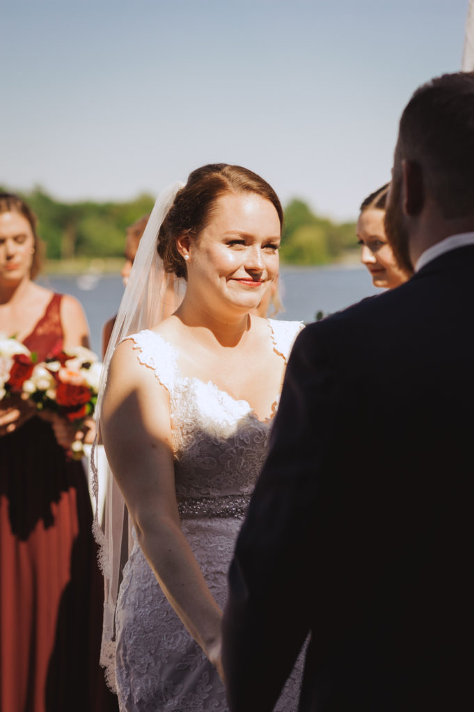 bride smiling at the groom during outdoor wedding ceremony