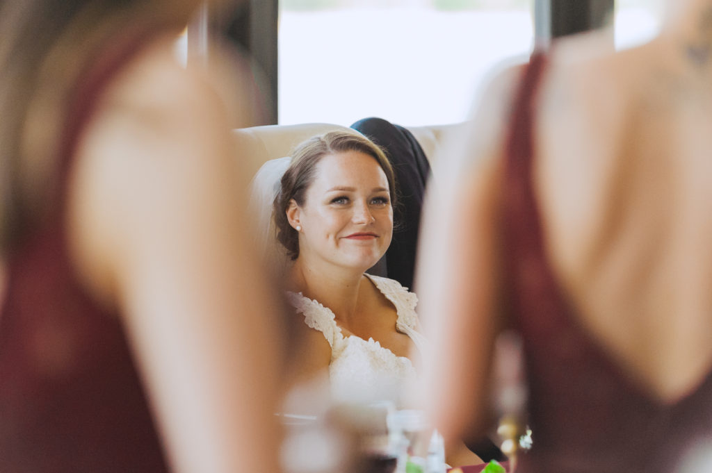 bride smiling at maid of honour speech