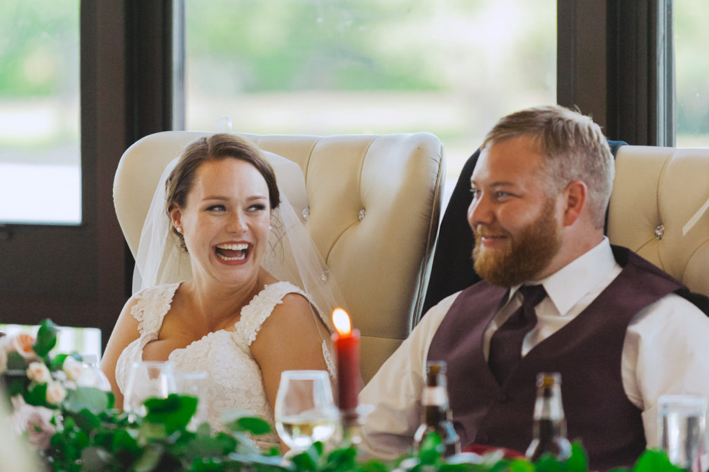 bride laughing at the groom during speeches