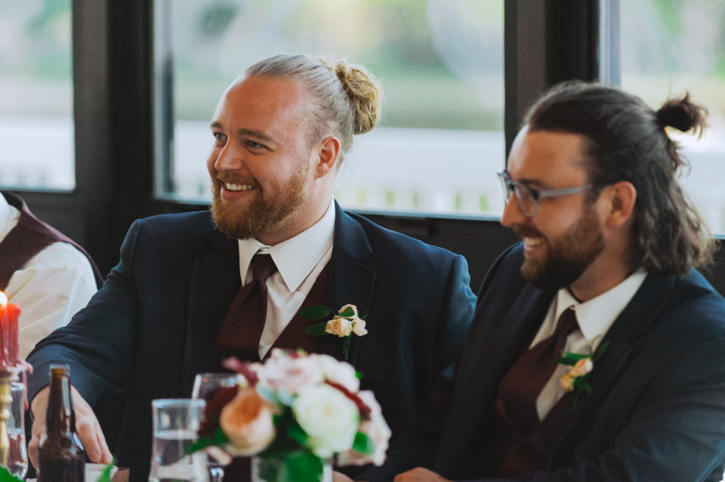 groomsmen laughing during speeches