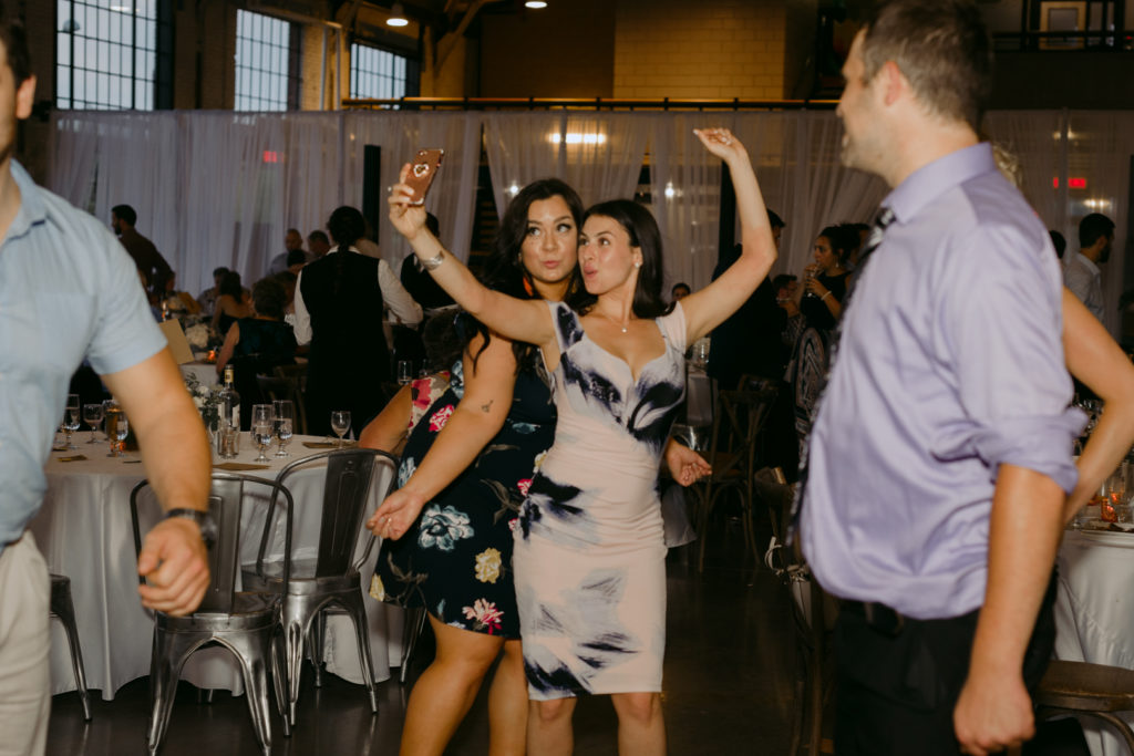 wedding guests taking a selfie on the dance floor