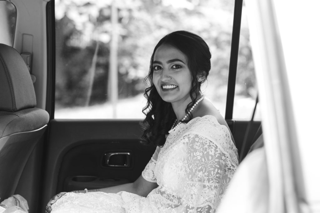 bride waiting in the backseat of a car for the ceremony to begin