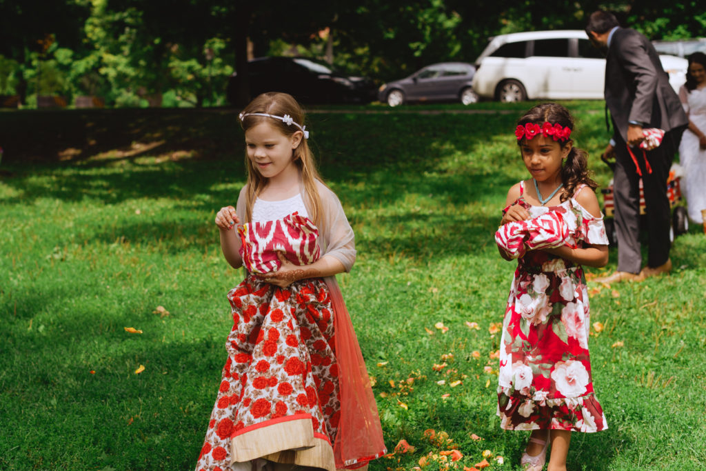 flower girls throwing rose petals as they walk tot he ceremony