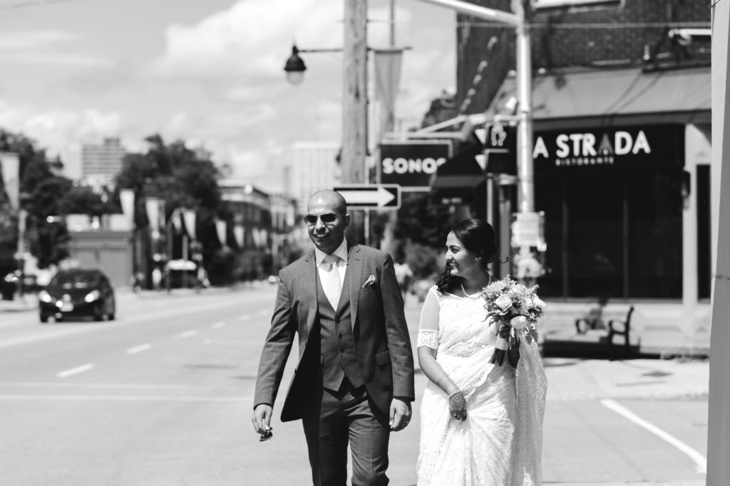 bride and groom walking down Bank Street in Ottawa