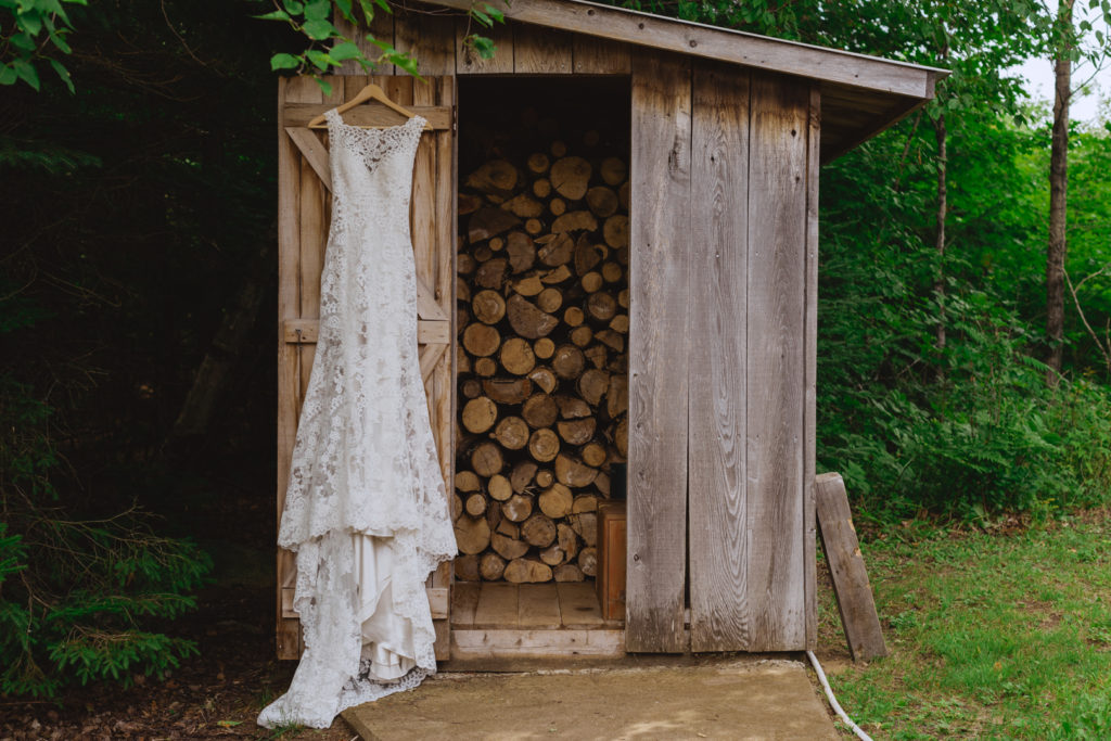 bride's lace gown hanging outside woodshed