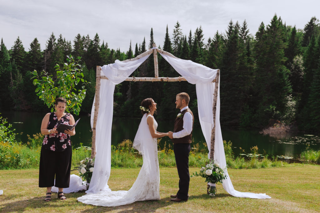 bride and groom standing under the birch tree altar