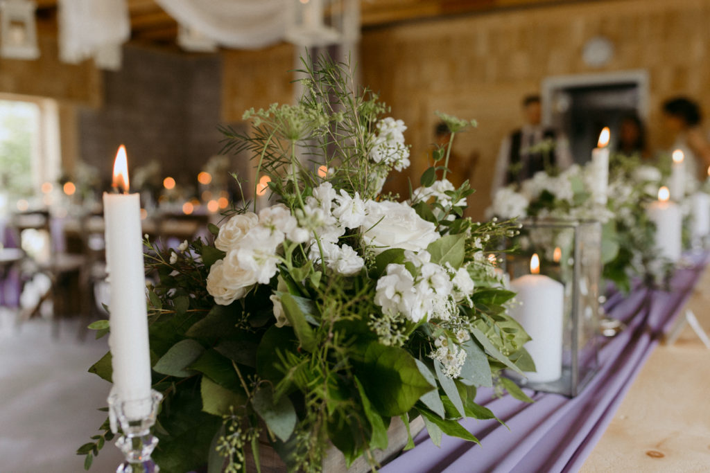 head table with flowers and candles