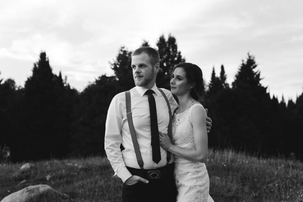 black and white portrait of bride and groom at the top of a hill