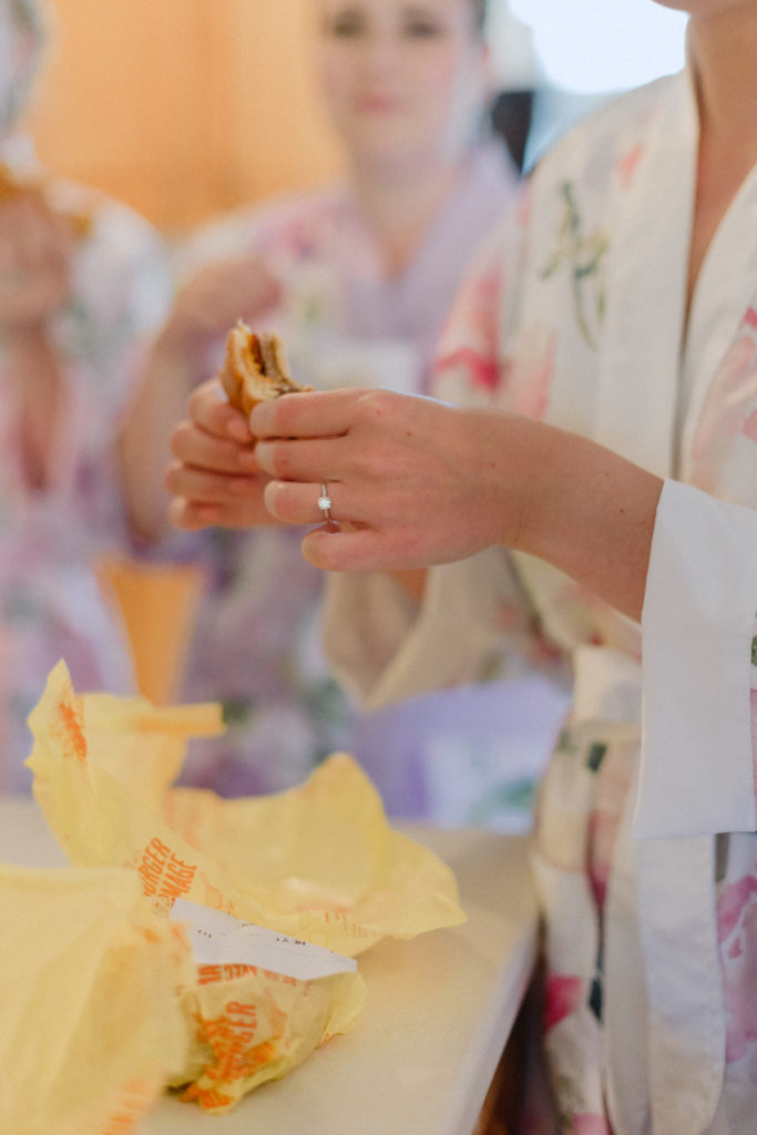bride holding a McDonalds cheeseburger