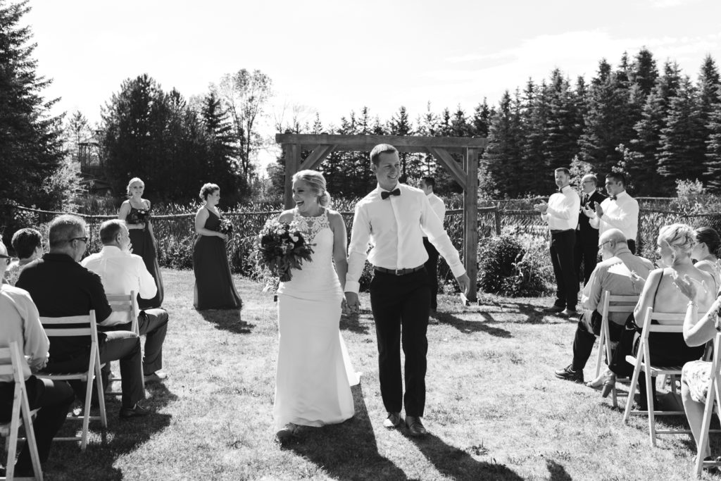 bride and groom walking down the aisle as husband and wife