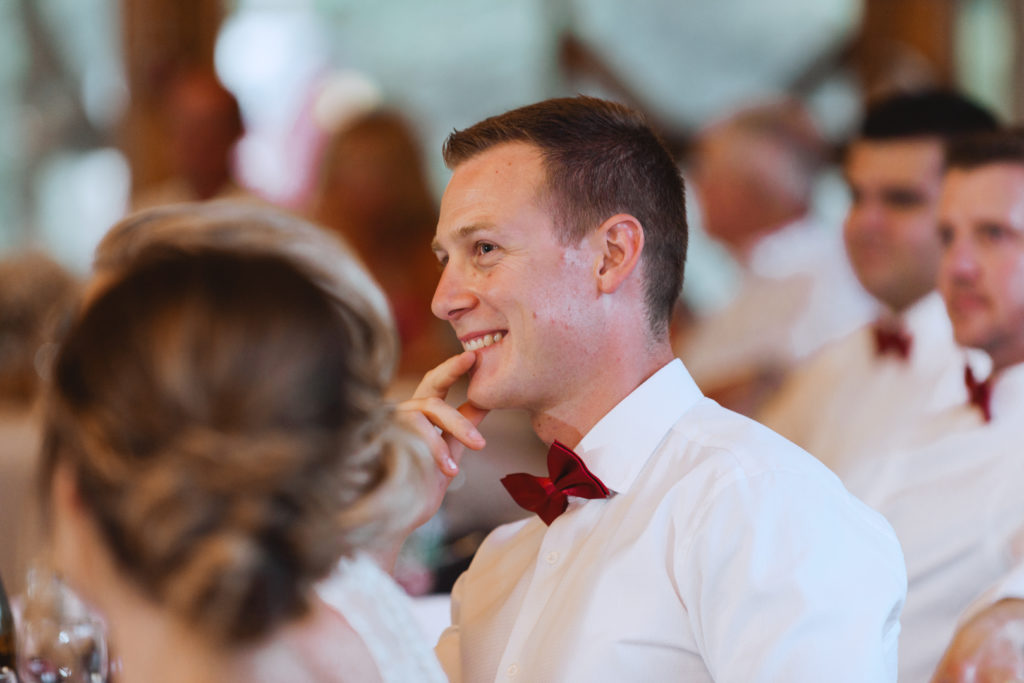 groom smiling during speeches