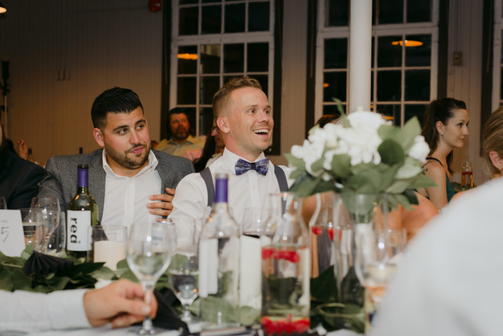 groomsman laughing at bride and groom speech