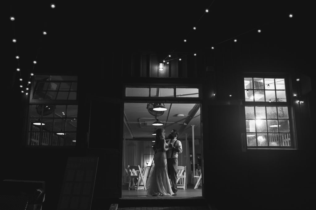 first dance inside a barn with twinkly lights
