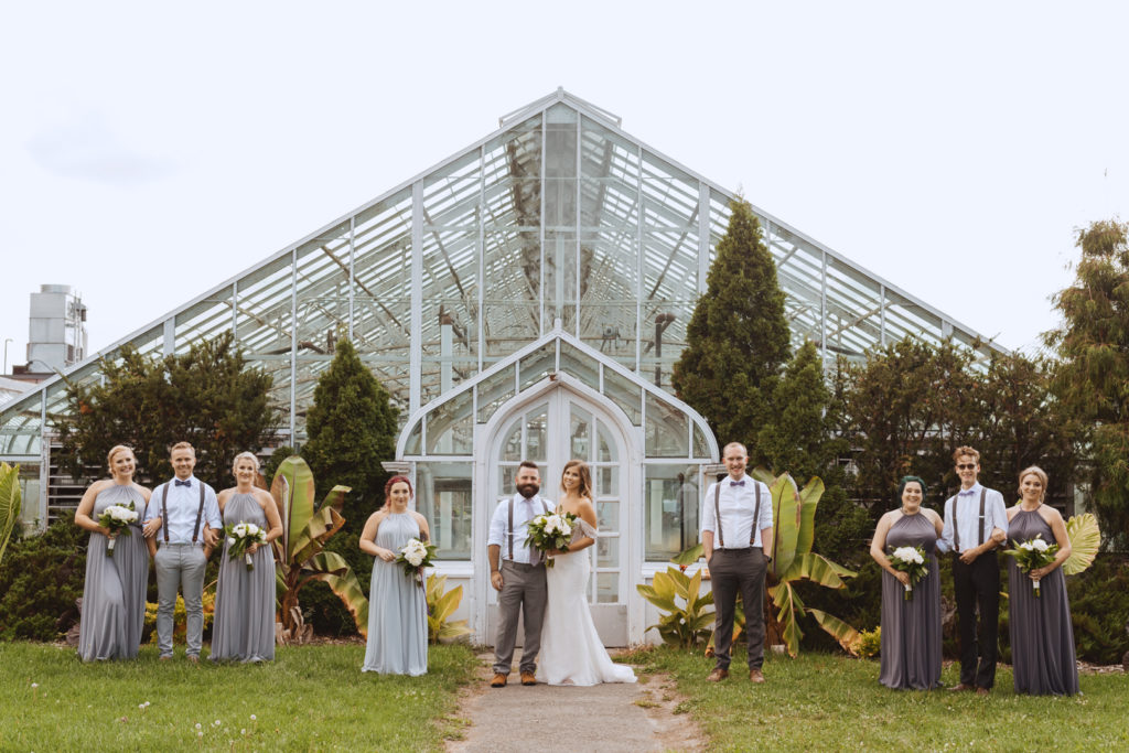 wedding party in front of greenhouse at the experimental farm