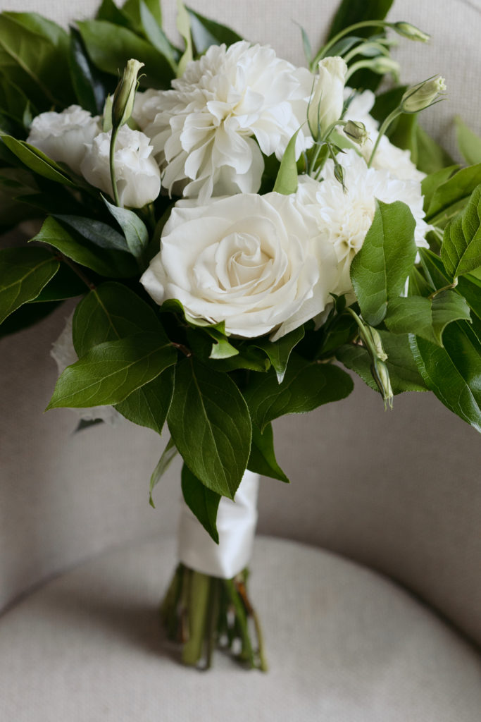 white and green bridal bouquet on chair