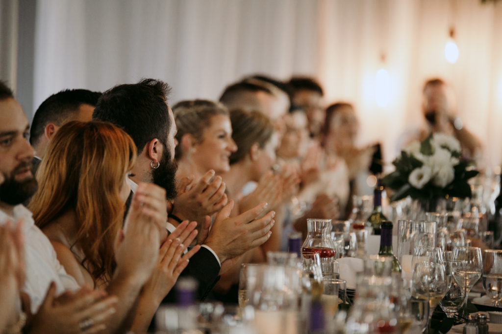 wedding guests applauding at wedding reception