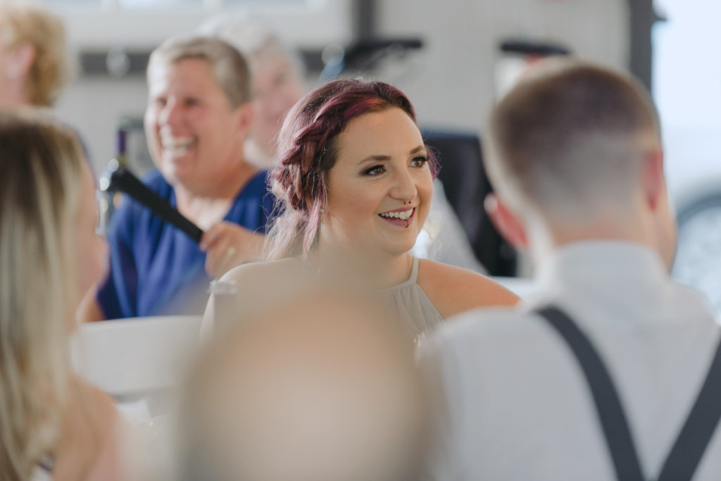 bridesmaid laughing during wedding speeches