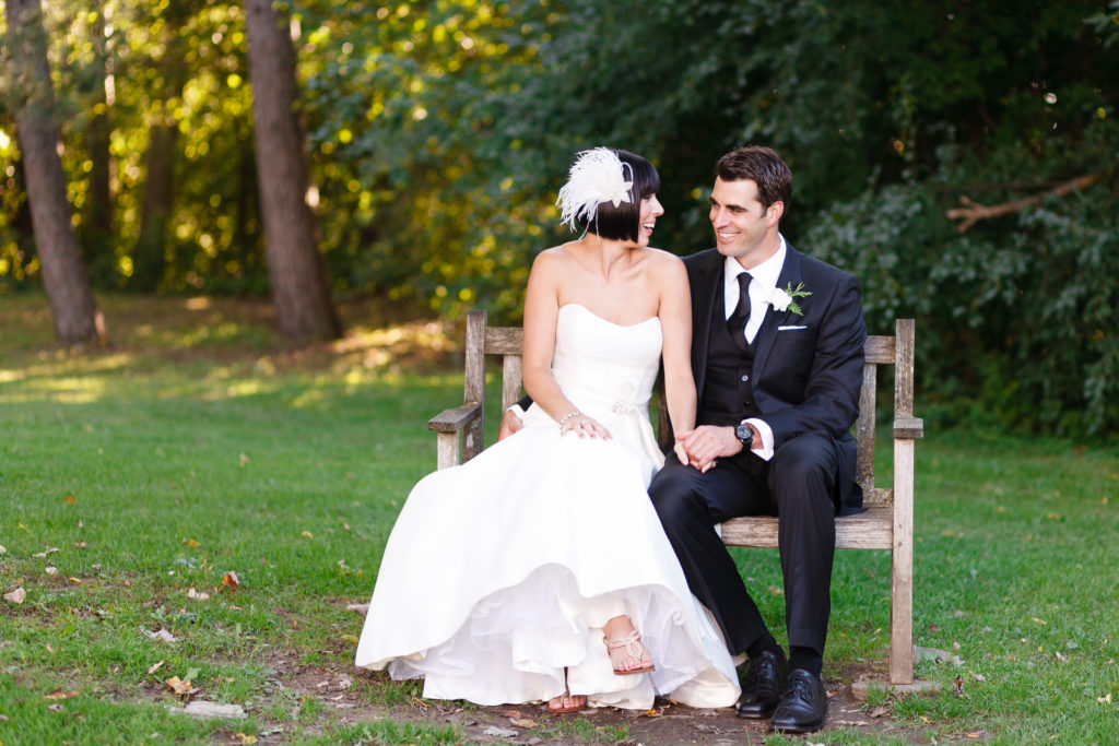 bride and groom sitting on a bench at the billings estate museum