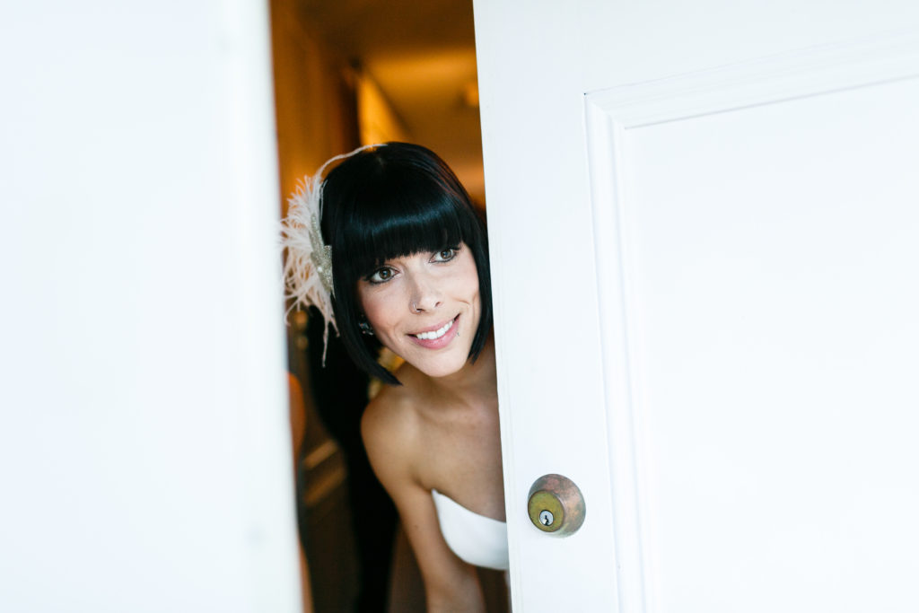 bride peeking out at wedding ceremony about to begin