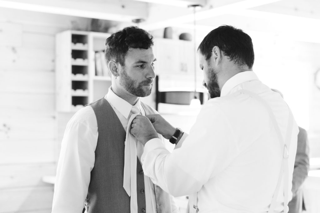 groomsmen putting on their ties