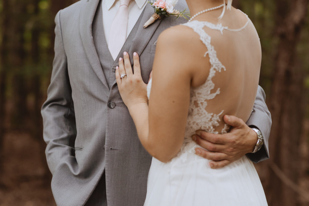 groom putting his arm around the bride's waist