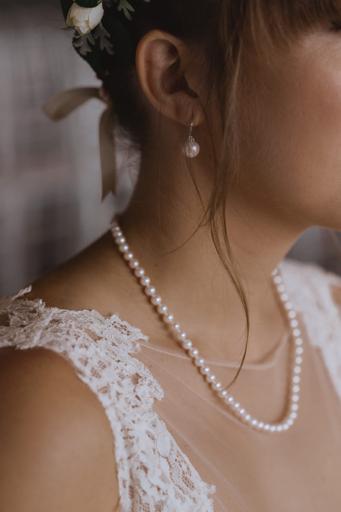 bride wearing pearl earrings and necklace