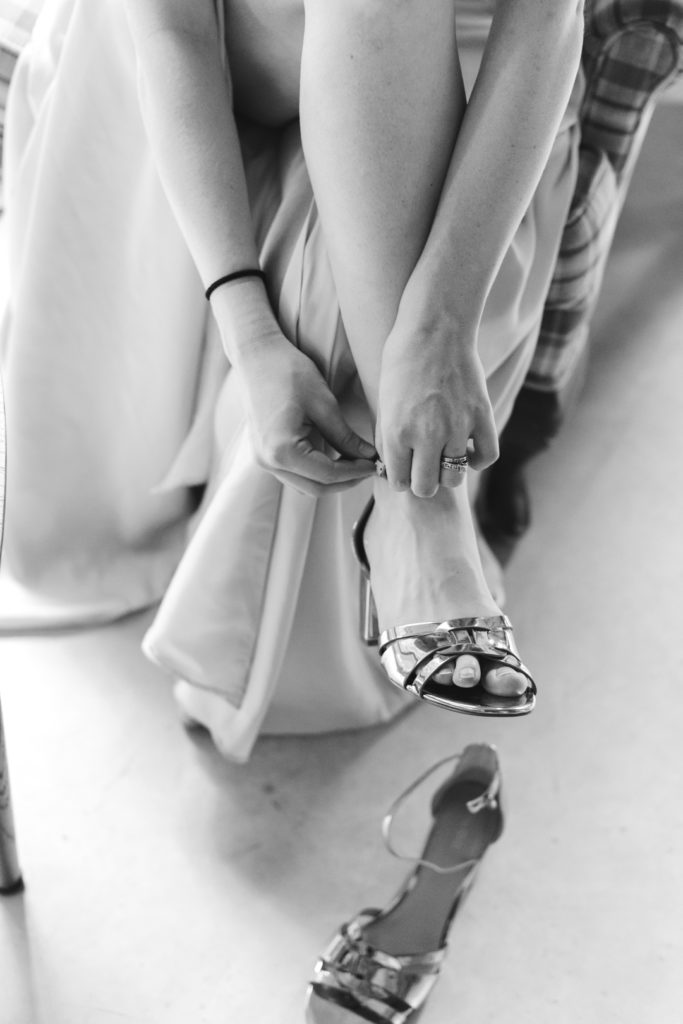 bridesmaid tying up her strappy sandals