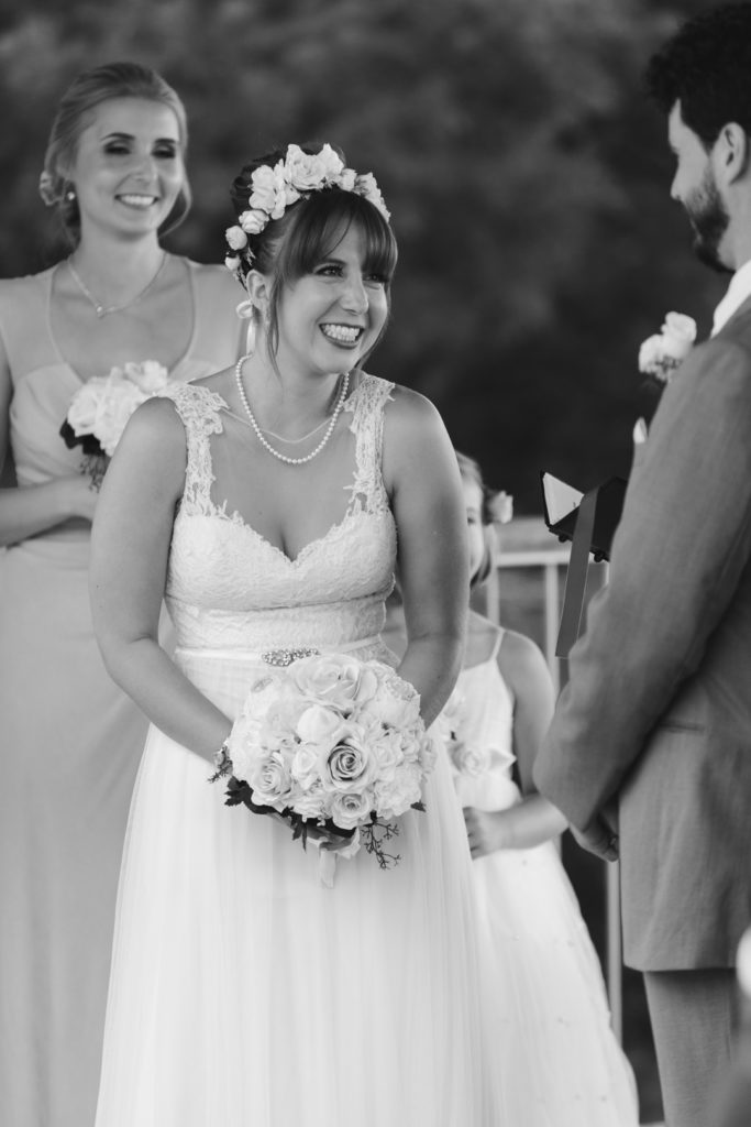 bride smiling at the groom during wedding ceremony