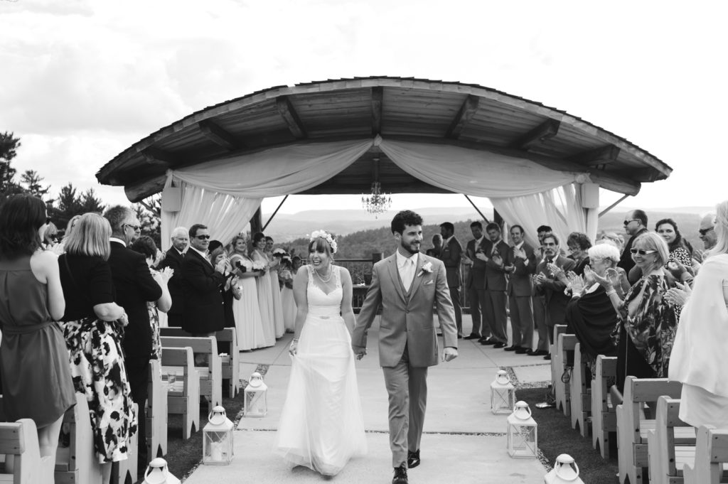 bride and groom walking down the aisle as husband and wife