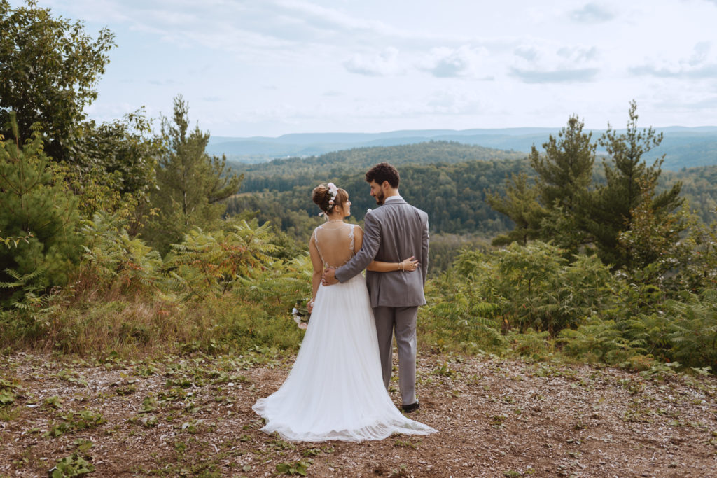 bride and groom overlooking Gatineau Hills at Le Belvedere