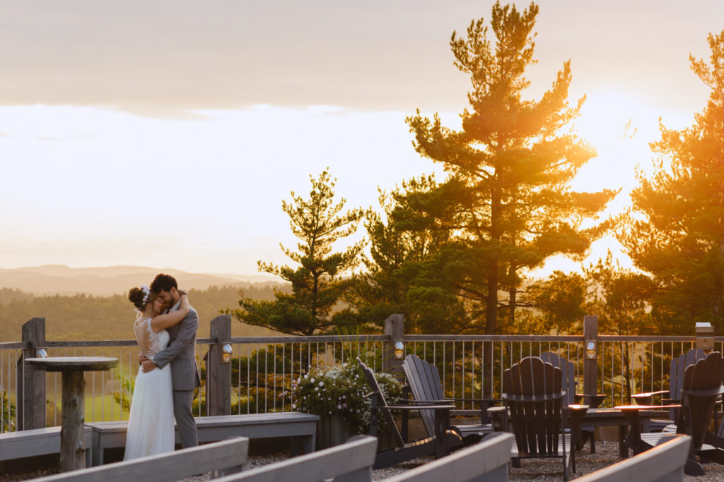 bride and groom cuddling at sunset